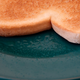 It will take some practice to properly butter a slice of toast without overspray.